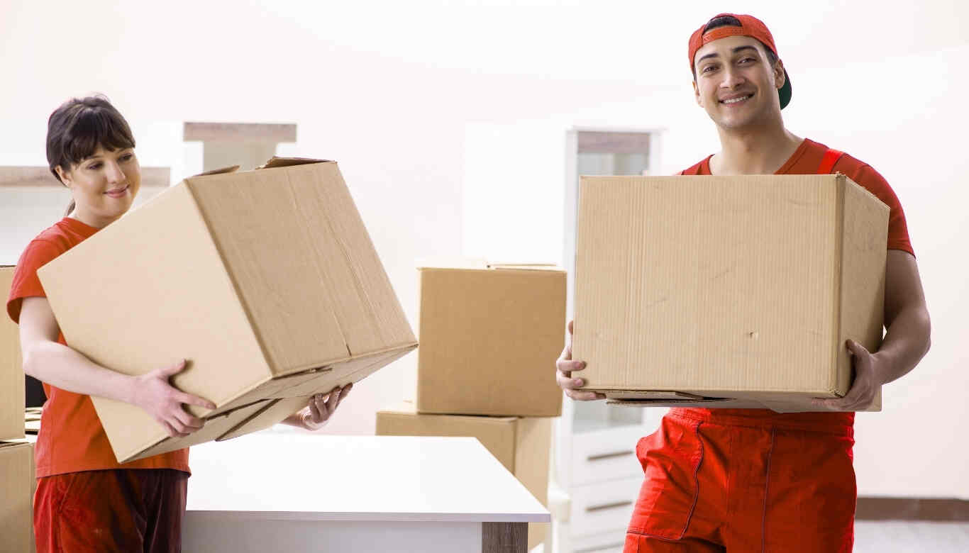 Trusted home shifting movers and packers team loading boxes and appliances