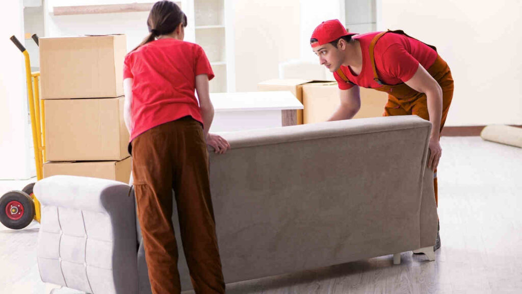 Workers safely wrapping a sofa, best furniture movers in Dubai